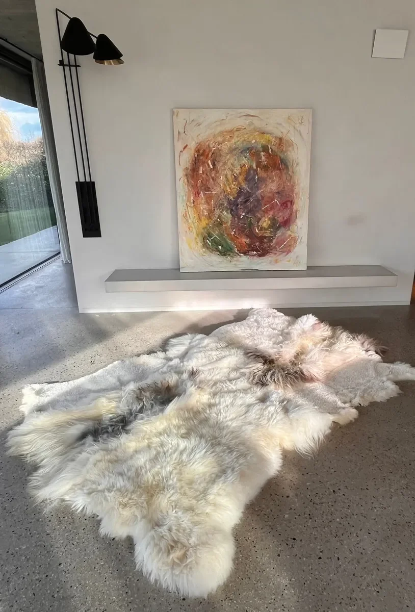 Oasis by Wol Society, a creamy white sheepskin rug with soft grey and smoky brown accents