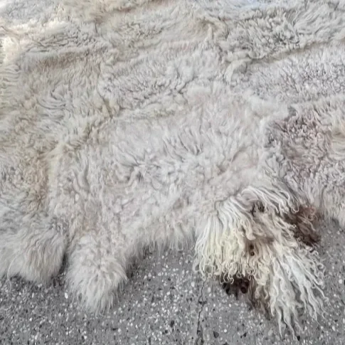 Blumi by Wol Society, a wavy soft white sheepskin rug with wavy curls
