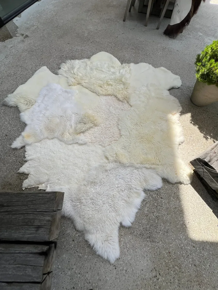 Sjoe by Wol Society, a near-square white sheepskin rug with smooth, curly and fluffy patches