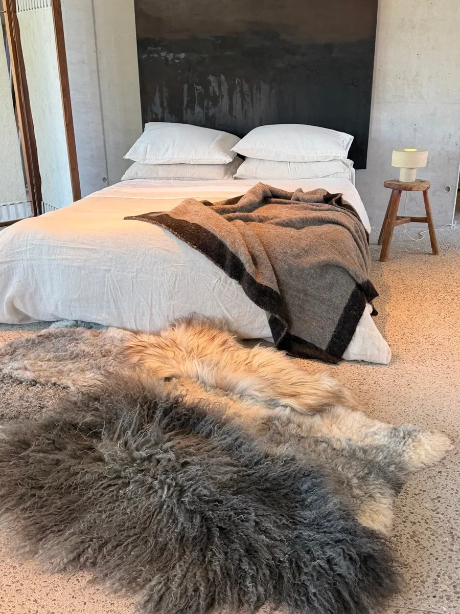 Frost by Wol Society, a grey sheepskin rug with long charcoal curls, silver pelts and honey tips