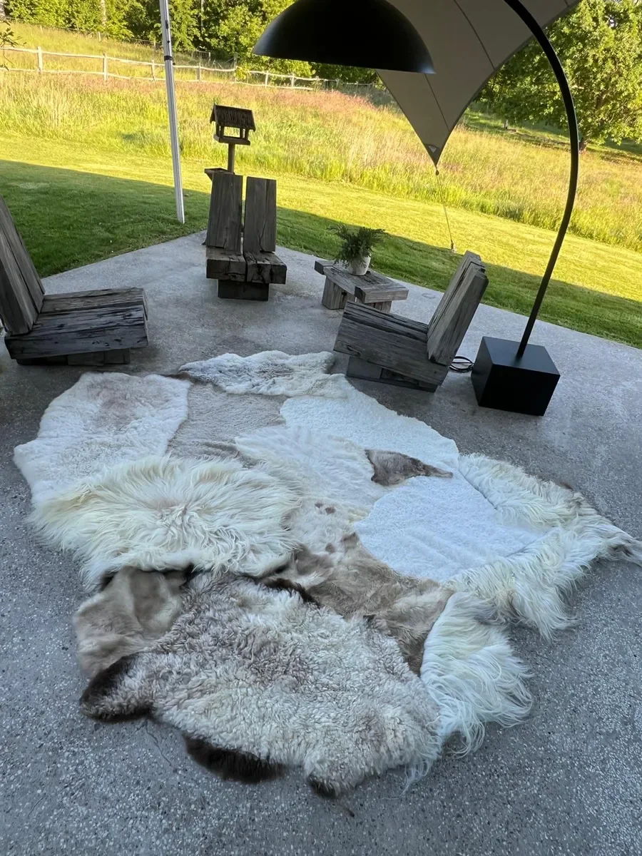 Poppy Puff by Wol Society, an ivory patchwork sheepskin rug with taupe spots and brown-edged pelts