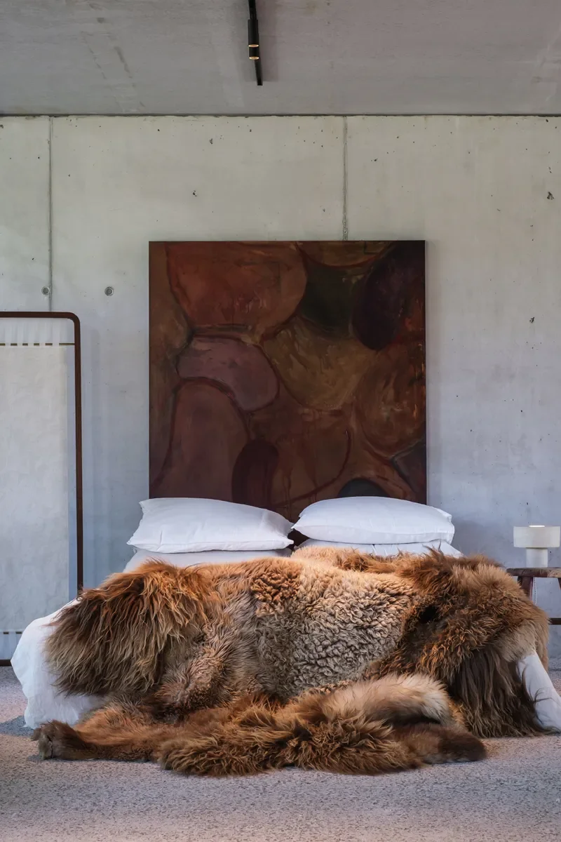 Snickers by Wol Society, a shaggy caramel and mocha sheep skin rug with a curly oatmeal center