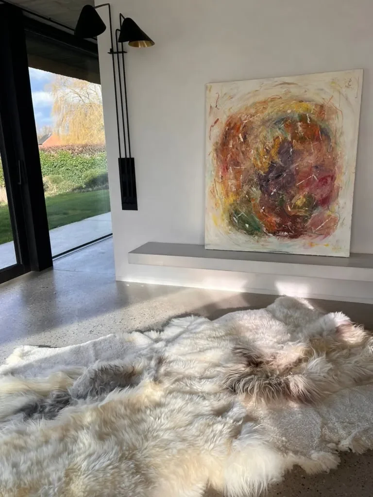 Oasis by Wol Society, a creamy white sheepskin rug with soft grey and smoky brown accents
