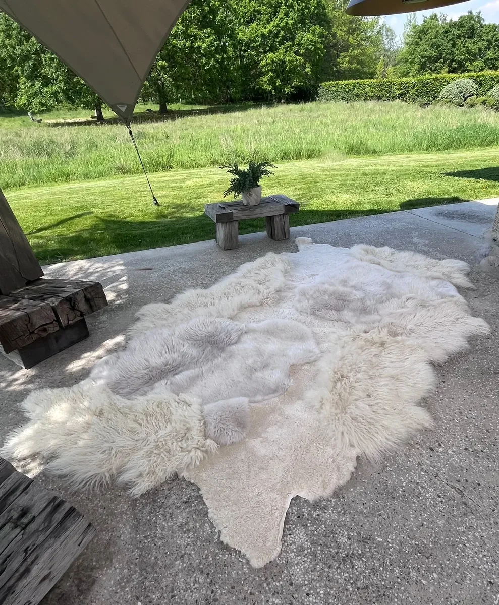 Mango by Wol Society, an ivory sheep skin rug with soft patches of pale dove grey
