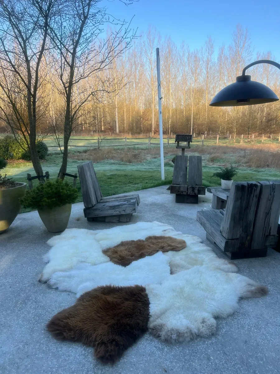 Wolkje by Wol Society, a white sheepskin rug with two chestnut and caramel brown pelts