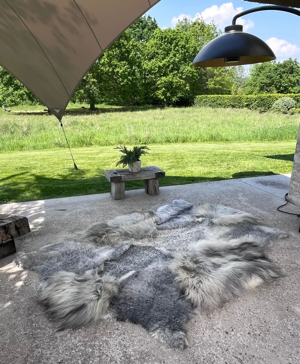 Graphite by Wol Society, a grey sheepskin rug in silver, slate and charcoal with long, silky waves