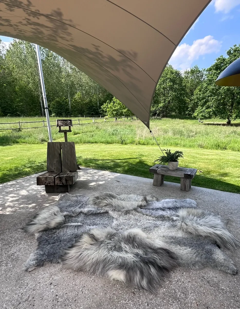 Graphite by Wol Society, a grey sheepskin rug in silver, slate and charcoal with long, silky waves