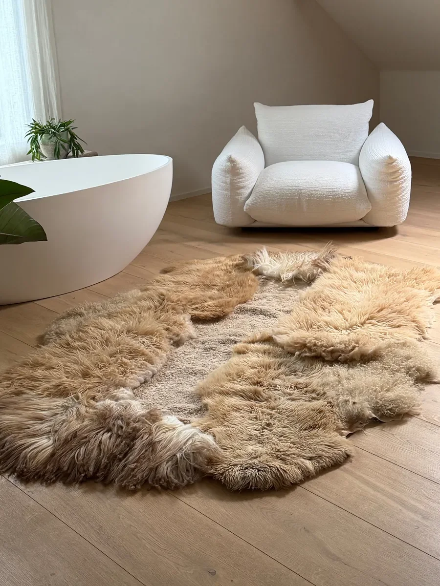 Kamiel by Wol Society, a golden ginger sheep skin rug with long, shaggy fleece and a sandy center
