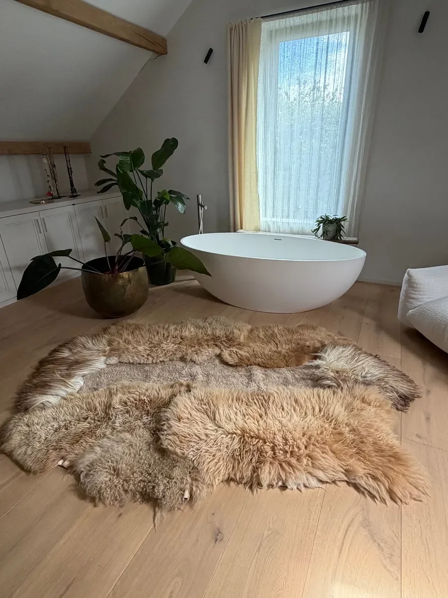 Kamiel by Wol Society, a golden ginger sheep skin rug with long, shaggy fleece and a sandy center