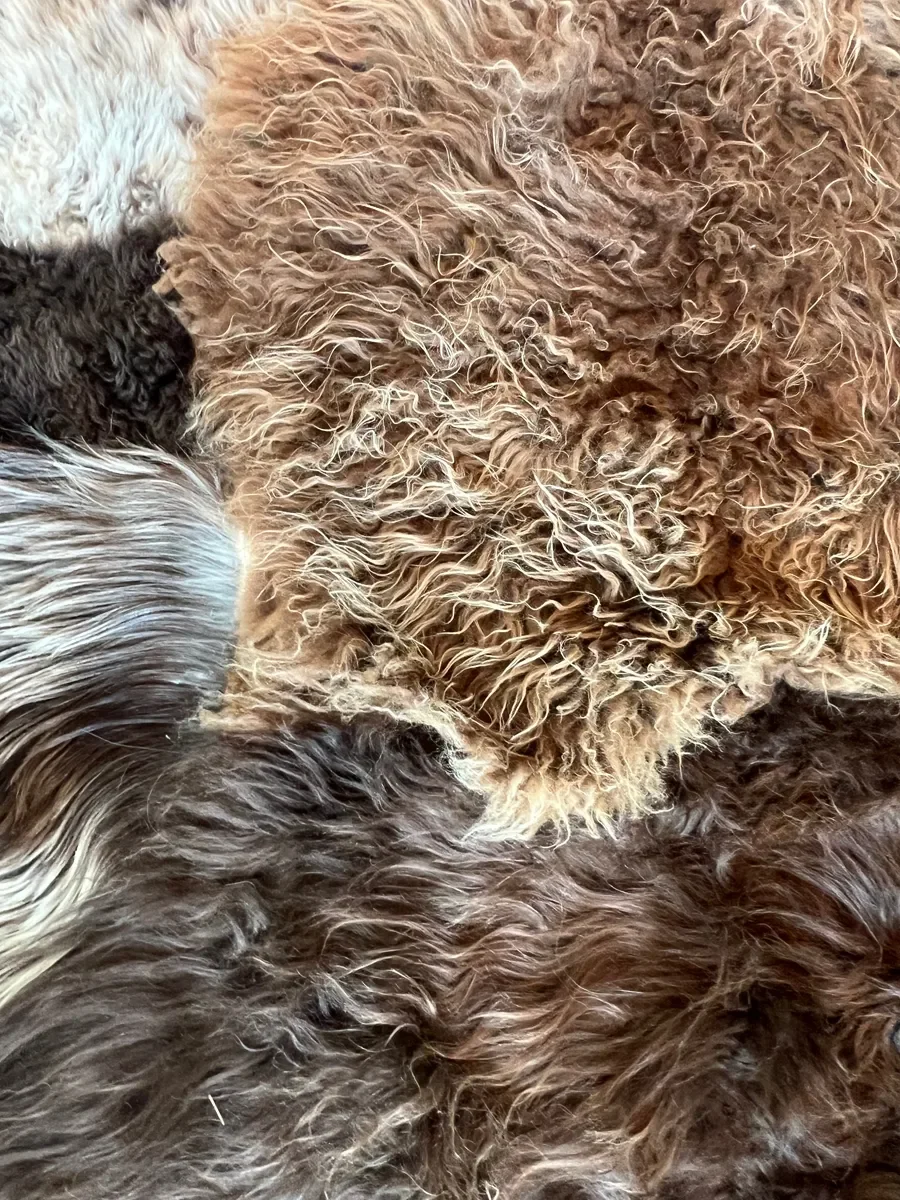 Joep by Wol Society, a brown and grey patchwork sheepskin rug with long, layered fleece