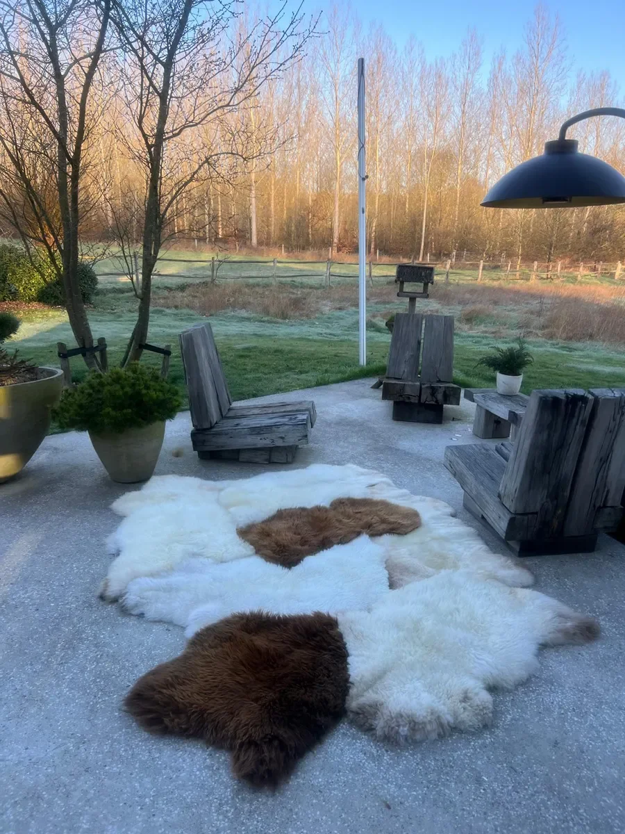Wolkje by Wol Society, a white sheepskin rug with two chestnut and caramel brown pelts