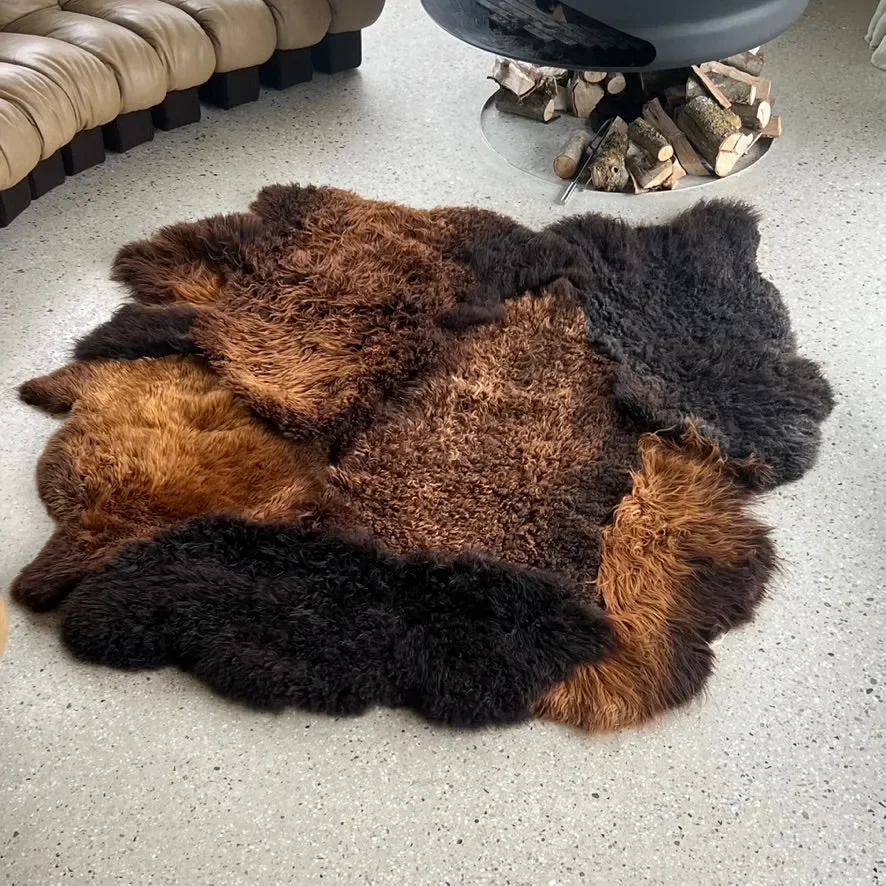 Tosca by Wol Society, a brown sheepskin rug with shaggy espresso and chestnut pelts