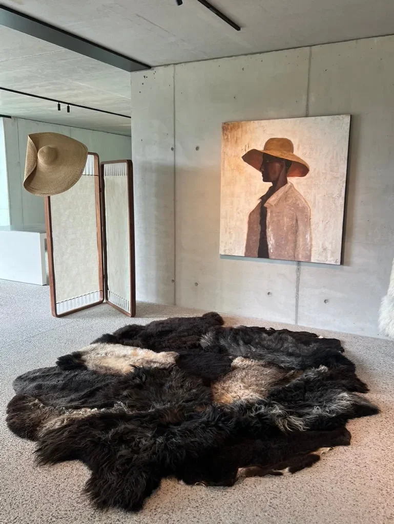Joske by Wol Society, a large dark brown sheepskin rug with honey, taupe and silvery curly pelts