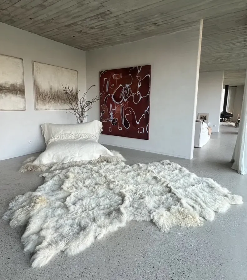 Pixie 2 by Wol Society, an ivory sheep skin rug with long, wavy fleece and soft grey undertones