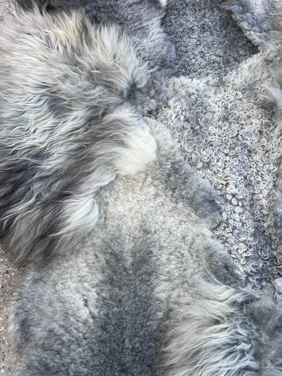 Graphite by Wol Society, a grey sheepskin rug in silver, slate and charcoal with long, silky waves