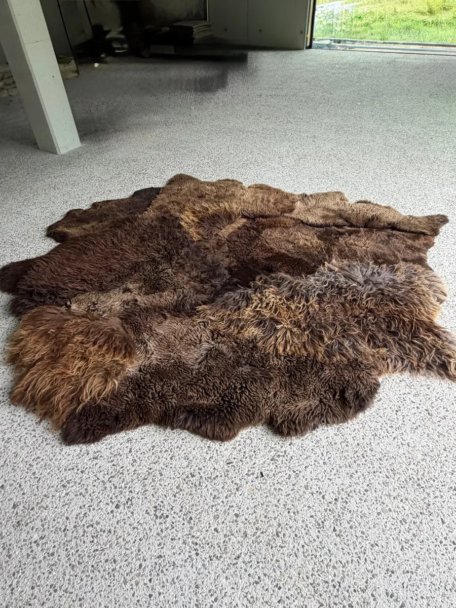 Kai by Wol Society, an ivory and cream sheep skin rug with long, gently wavy fleece