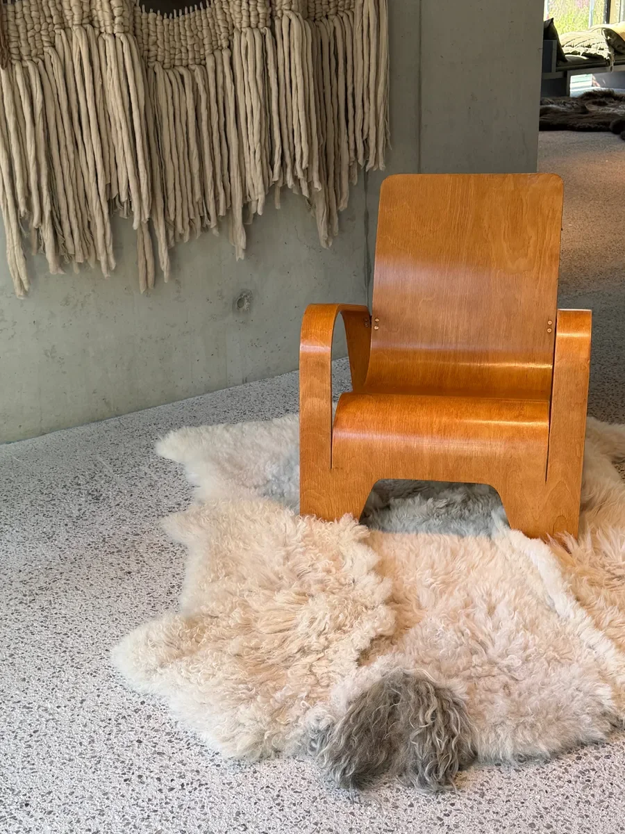 Crumble by Wol Society, a curly ivory and oatmeal sheep skin rug with a shaggy grey tuft