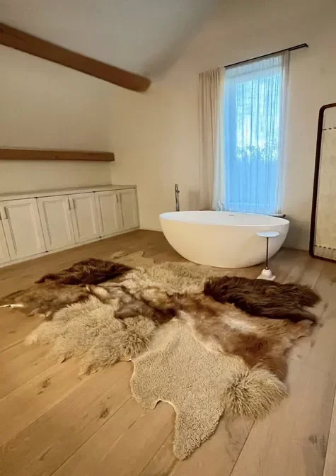 Cobra by Wol Society, a brown and cream patchwork sheepskin rug with long chestnut and curly cream fleece