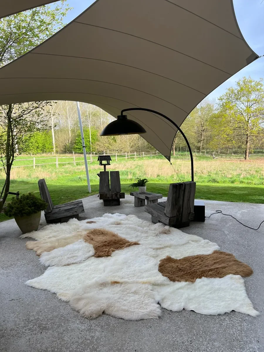 Coqui by Wol Society, a huge white sheepskin rug with two caramel pelts