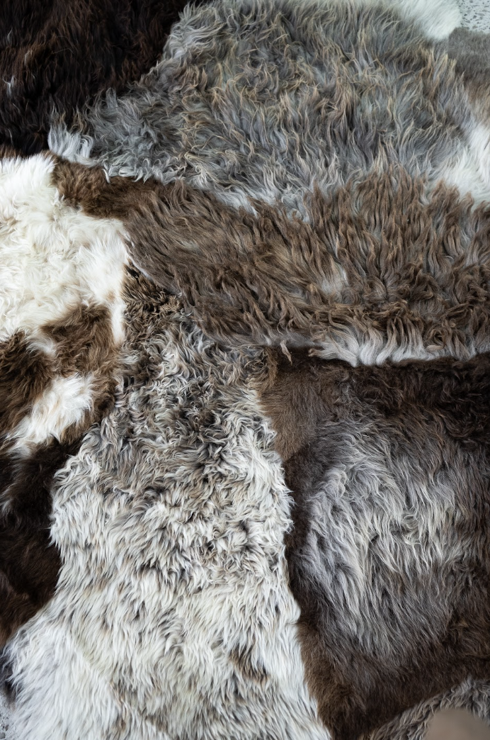 Breezy by Wol Society, a patchwork sheepskin rug in chocolate, taupe and frosted grey with one brown-and-white pelt