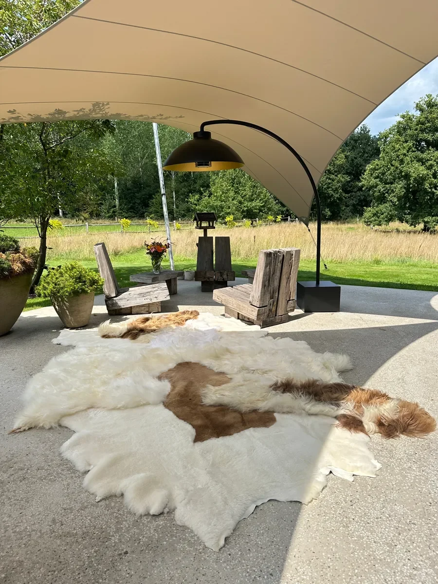 Mieke 190 by Wol Society, a large white sheepskin rug with a caramel brown pelt through its center