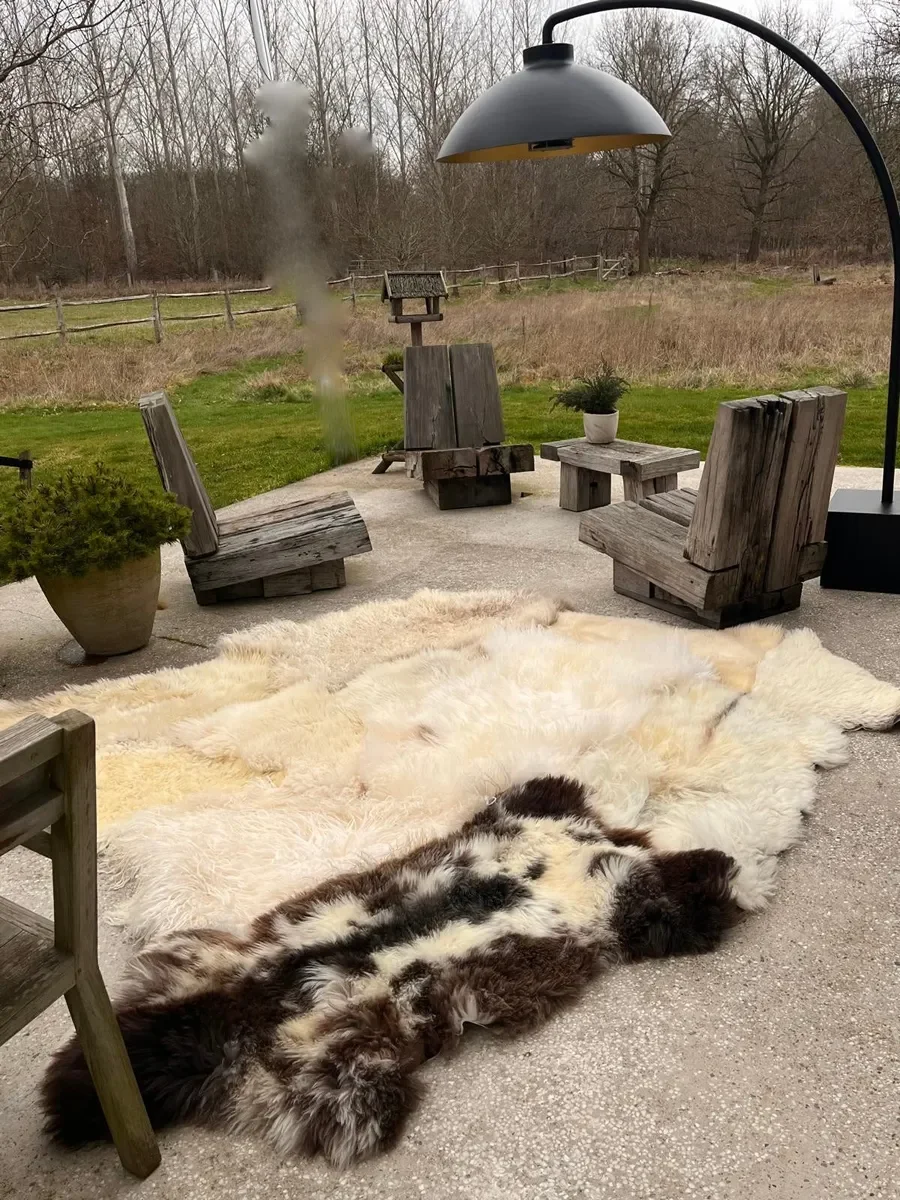 Pipper by Wol Society, a giant cream and ivory sheep skin rug with grey-brown curls and a speckled pelt