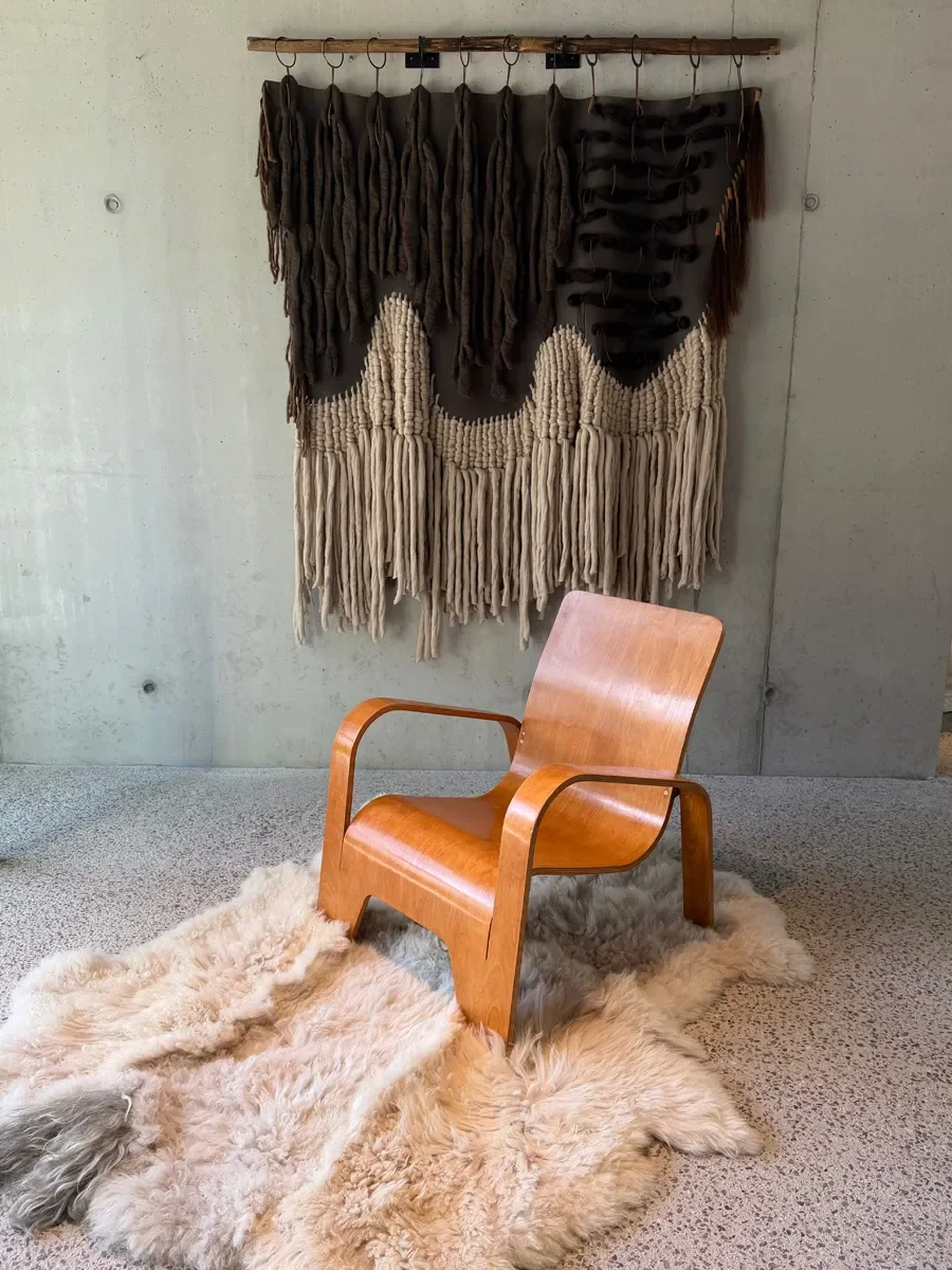 Crumble by Wol Society, a curly ivory and oatmeal sheep skin rug with a shaggy grey tuft