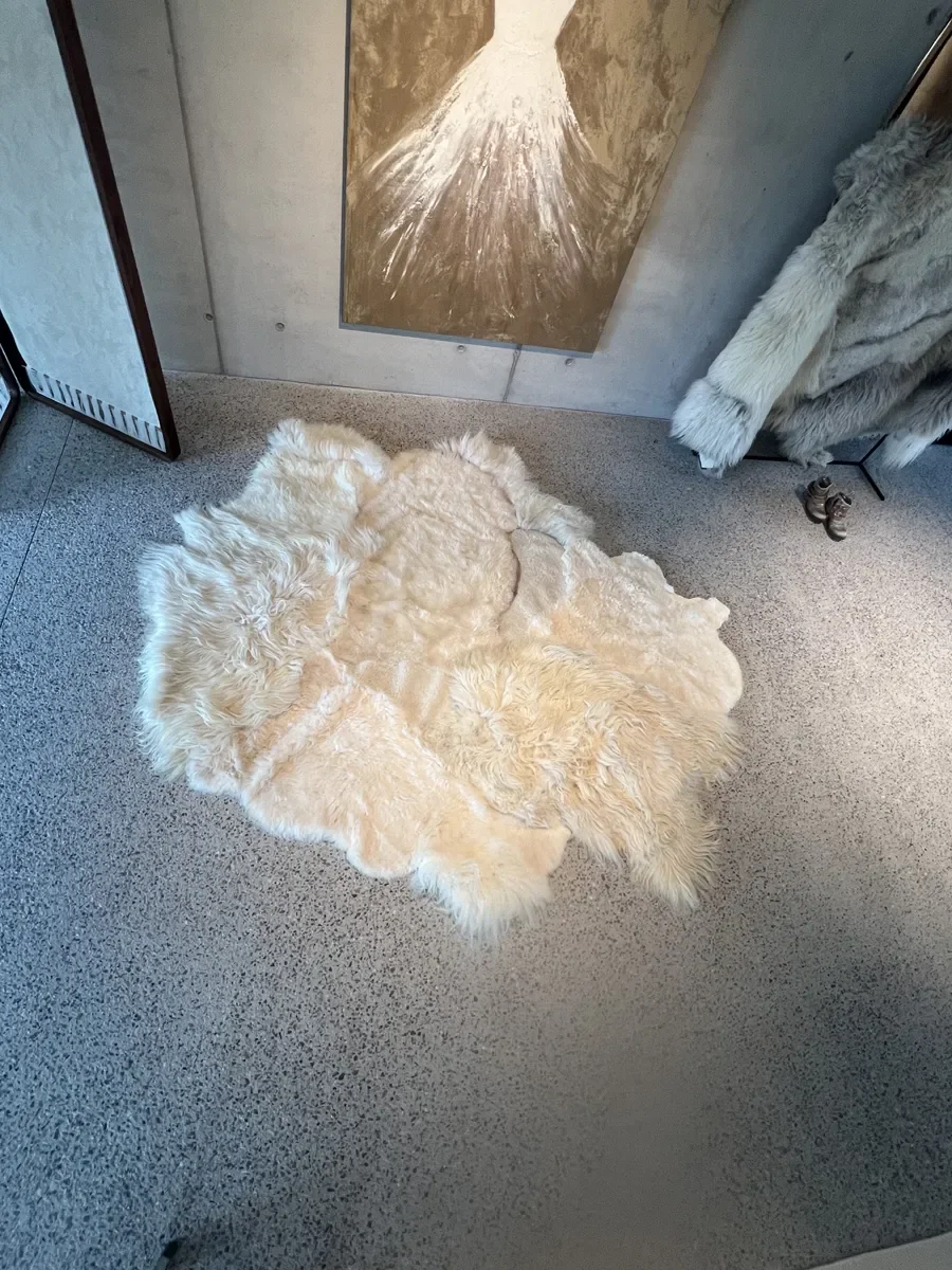 PomPom by Wol Society, a buttery cream sheep skin rug with long, fluffy edges