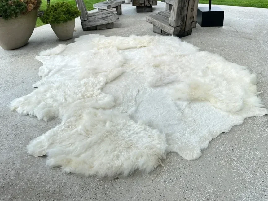 Mieke 189 by Wol Society, a large creamy white sheepskin rug with fluffy and smooth fleece