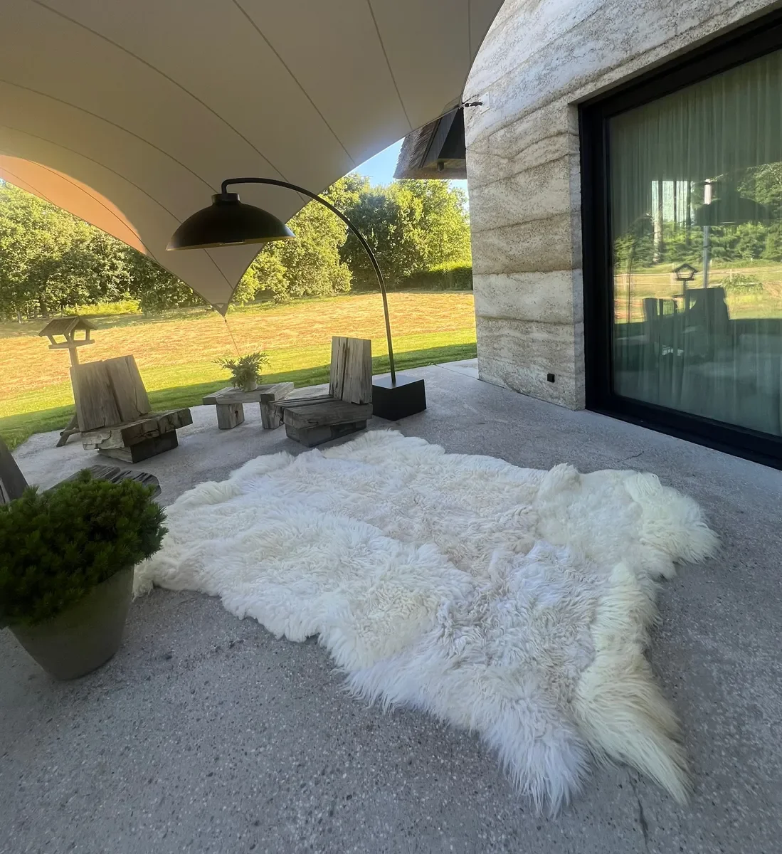 Winnie by Wol Society, a large creamy white sheepskin rug with long, airy fleece