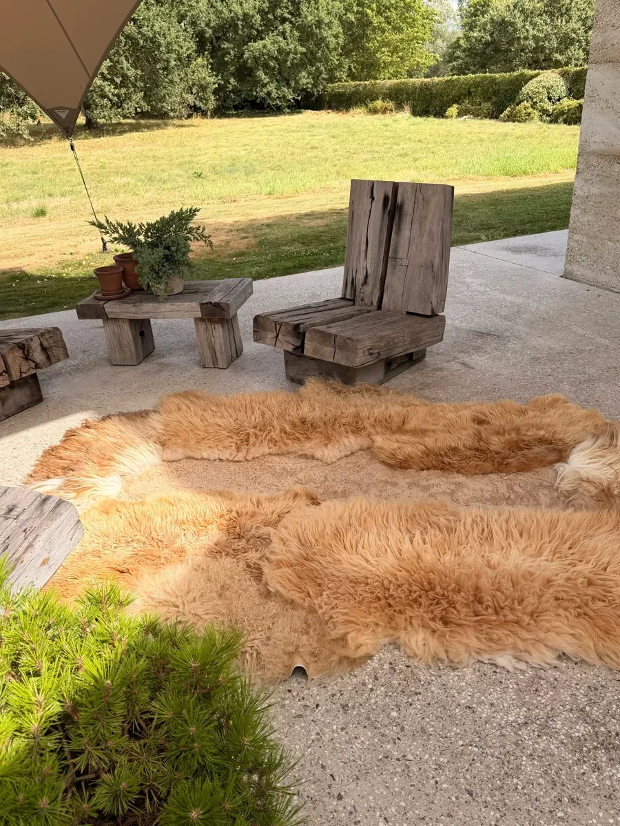 Kamiel by Wol Society, a golden ginger sheep skin rug with long, shaggy fleece and a sandy center