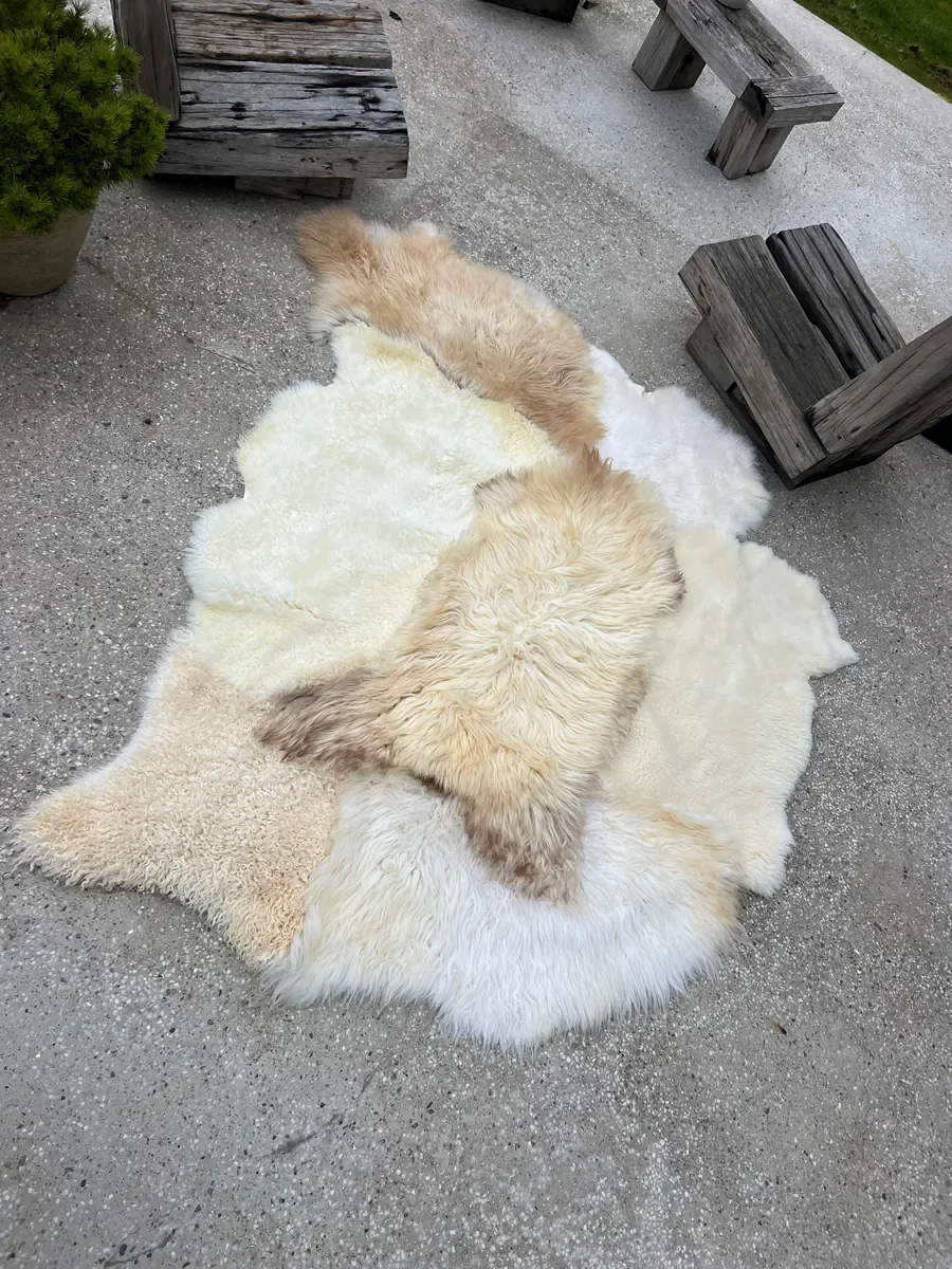 Nomad by Wol Society, a creamy white sheepskin rug with a honey and taupe pelt across the center