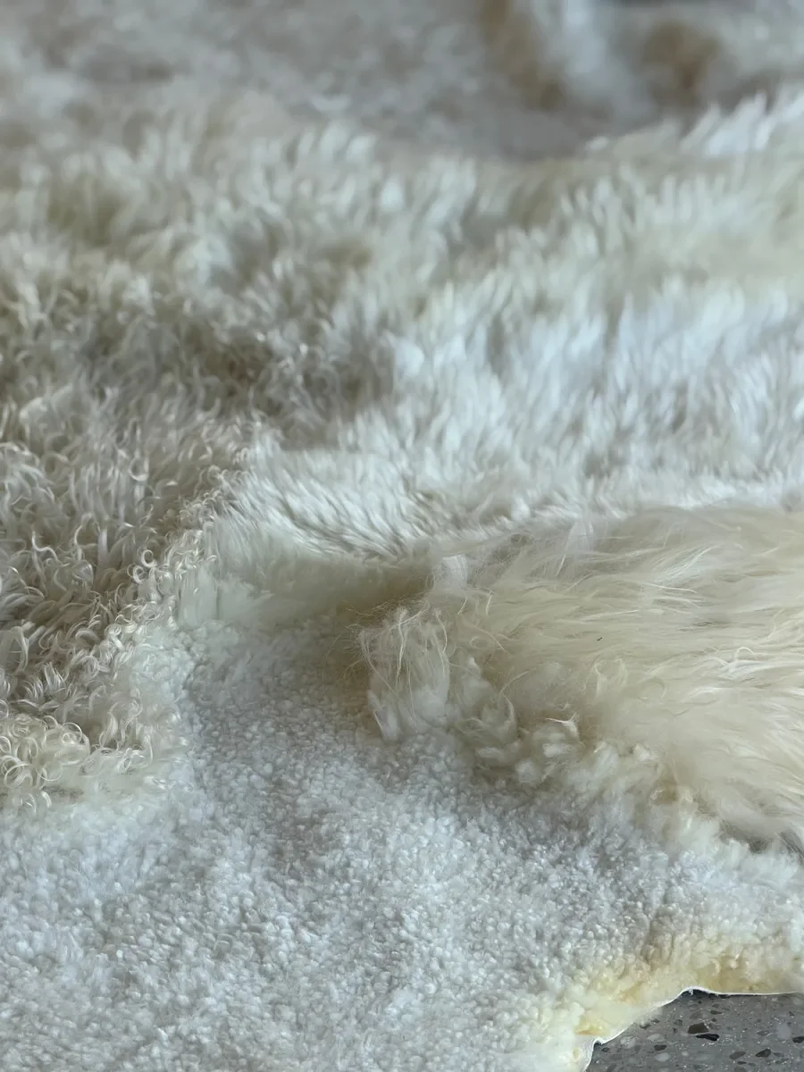 Milky Way by Wol Society, a white and cream sheep skin rug with a curly pale butter center