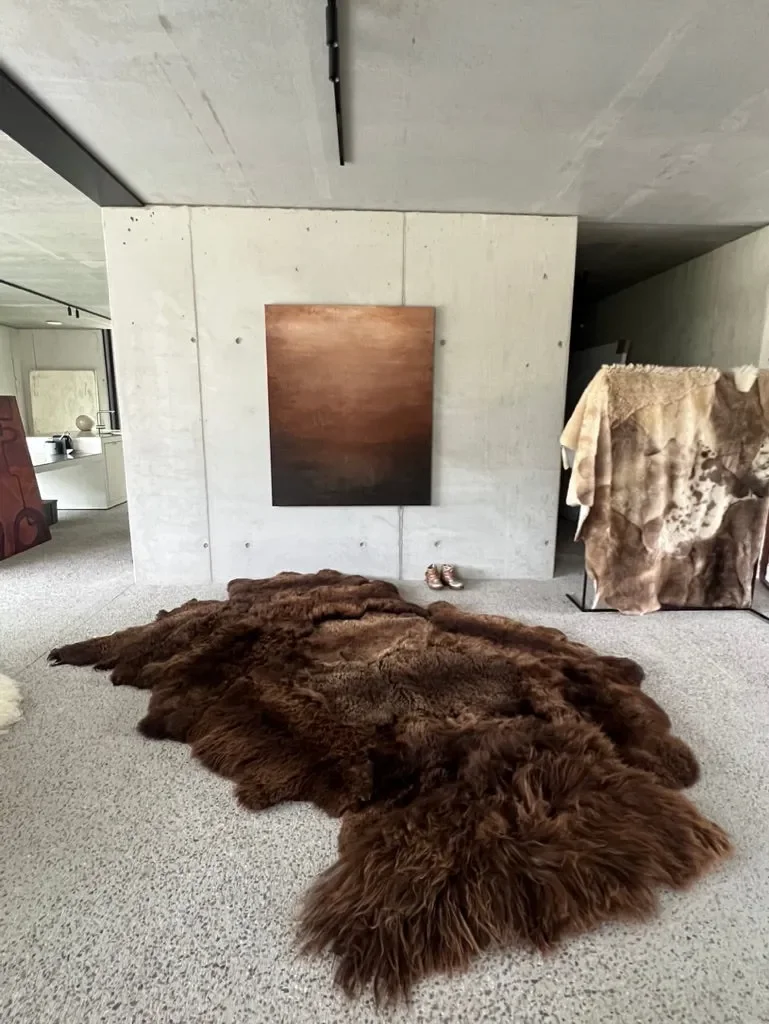 Mieke 204 by Wol Society, a russet brown sheepskin rug with shaggy edges and a curly center