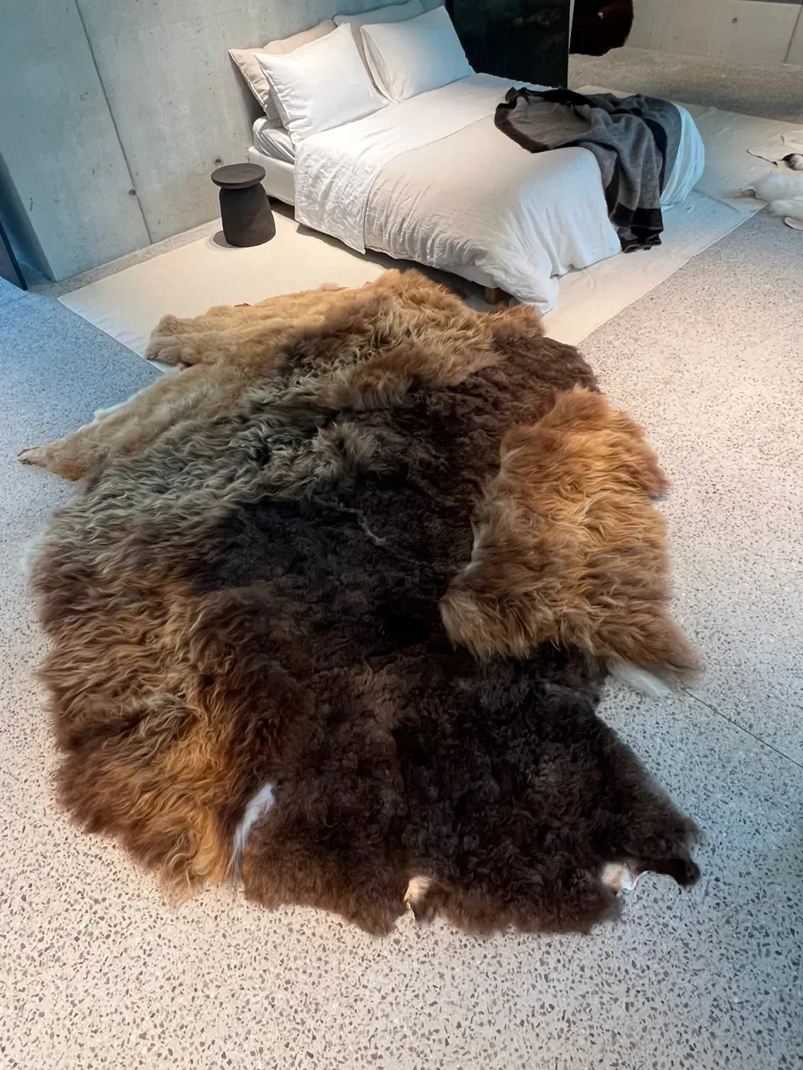 Mieke 203 by Wol Society, a shaggy brown sheepskin rug in chocolate, chestnut and copper