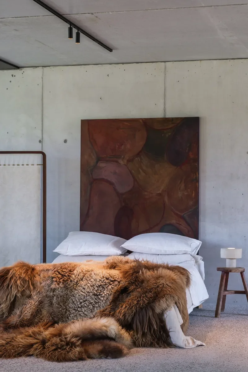 Snickers by Wol Society, a shaggy caramel and mocha sheep skin rug with a curly oatmeal center