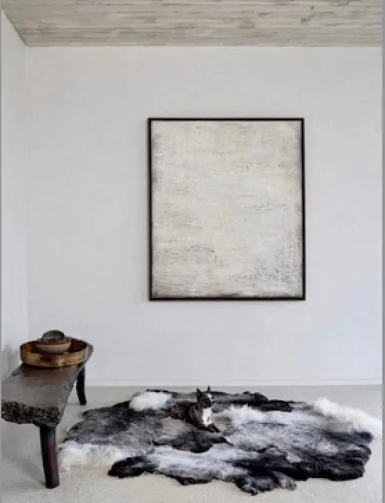 Piece Unique by Wol Society, a charcoal and silver grey Gotland lambskin carpet with tufts of white curls