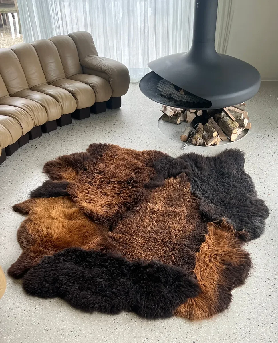 Tosca by Wol Society, a brown sheepskin rug with shaggy espresso and chestnut pelts