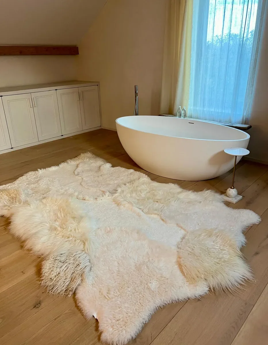 Silence by Wol Society, a buttery ivory sheep skin rug with smooth pelts and long, silky edges