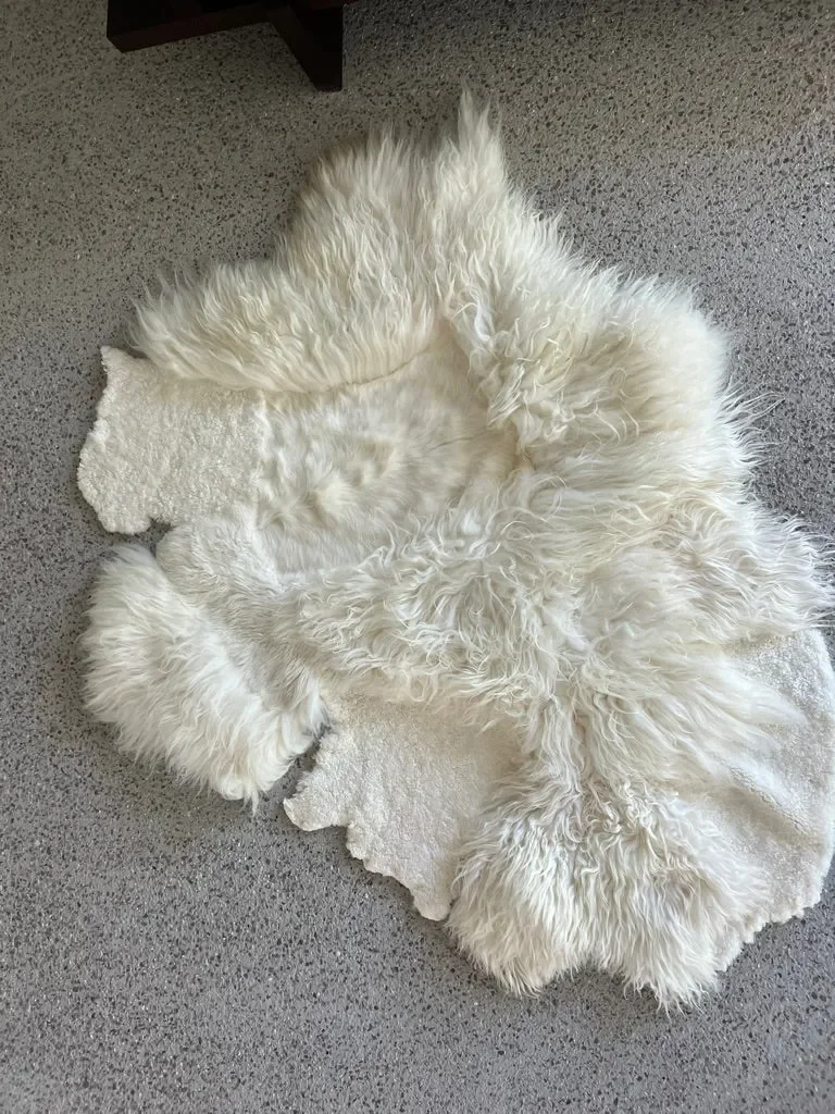 Gamin by Wol Society, an ivory sheep skin rug with long, airy fleece and smooth patches