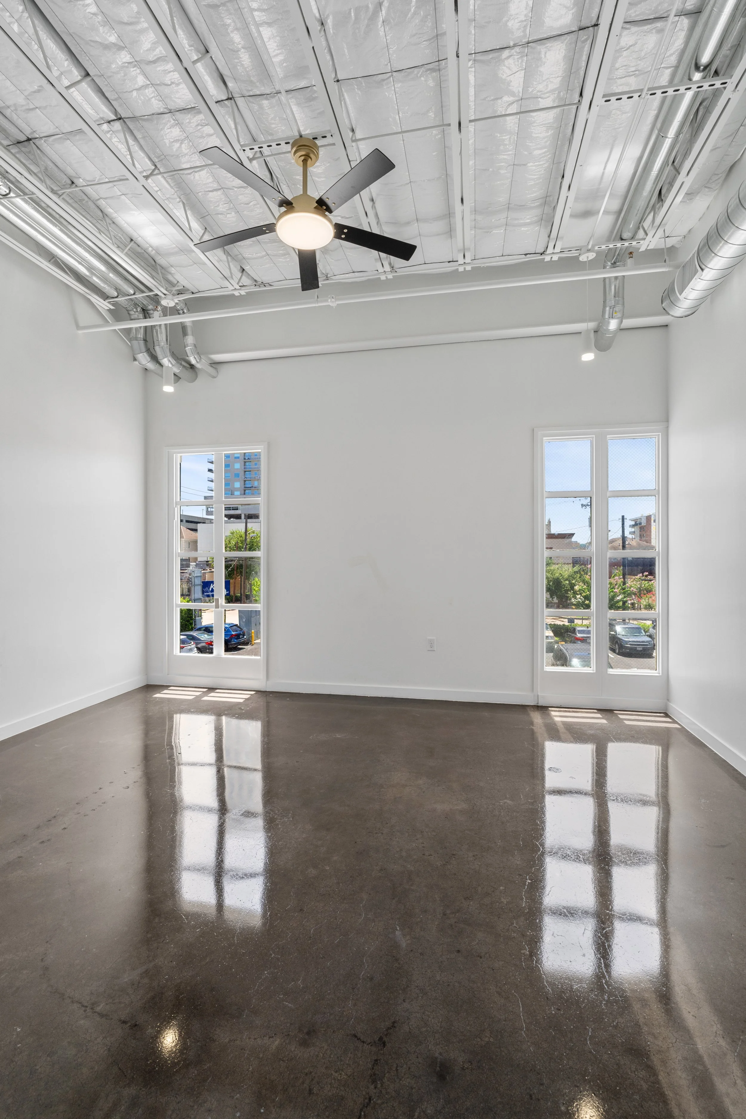 The Residences at Bienville bedroom with two windows that provide an abundance of natural light
