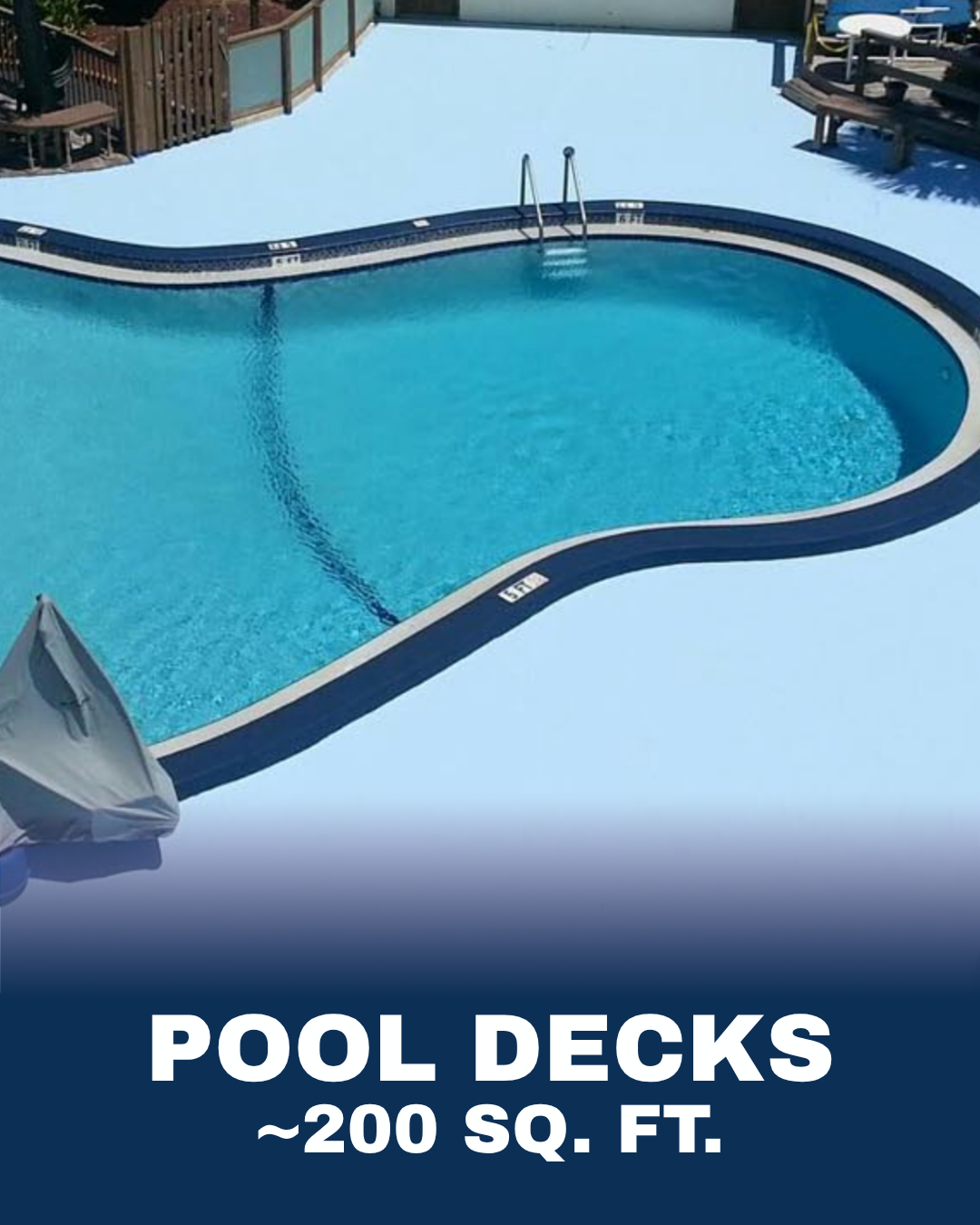 Empty swimming pool with a built-in step ladder, surrounded by a white deck, partial umbrellas, and nearby lounge chairs.