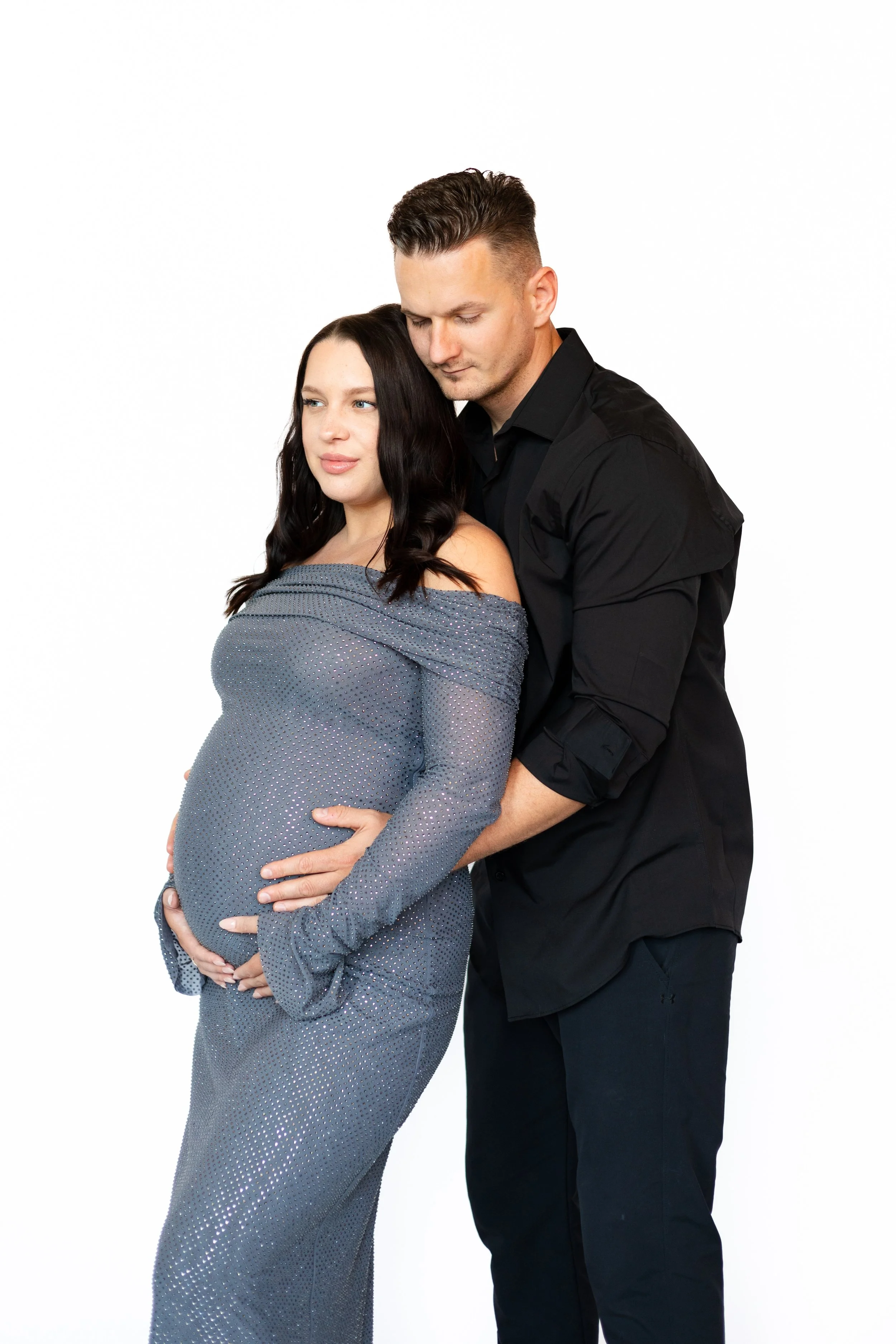 Expecting couple embracing during a maternity photography session in Utica New York