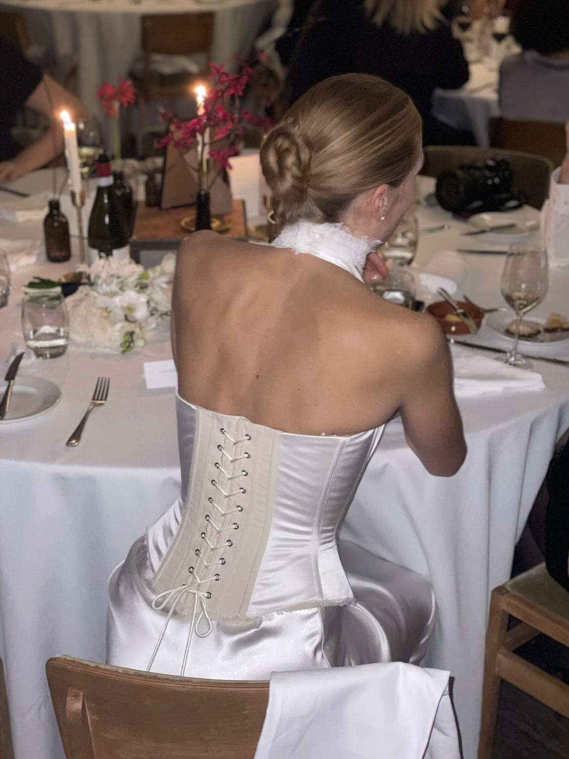 Earth Bridal ivory satin corset with waxed lace back, worn by a bride at her reception, made in London