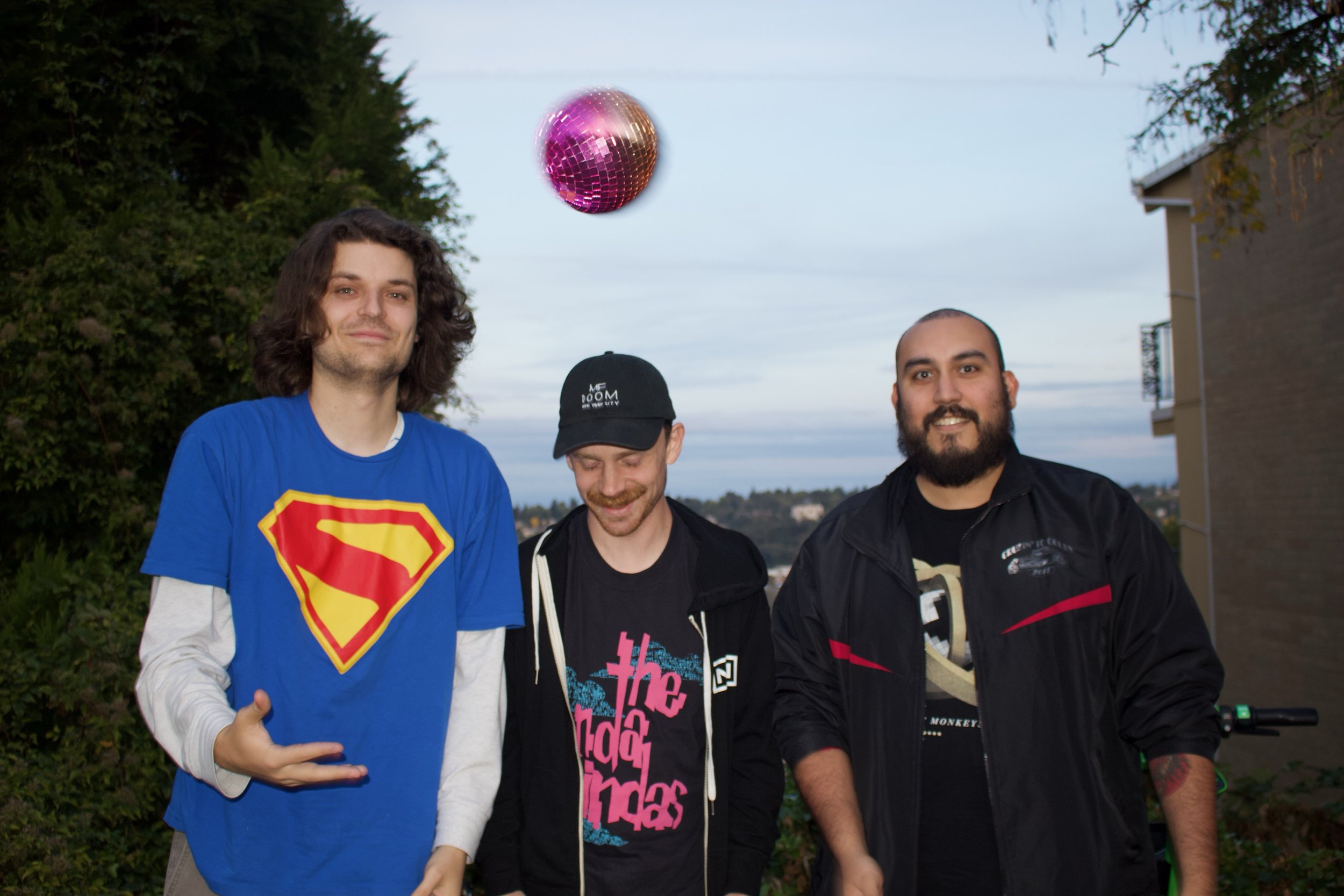 Former Jock posing for a photo with a floating pink disco ball.