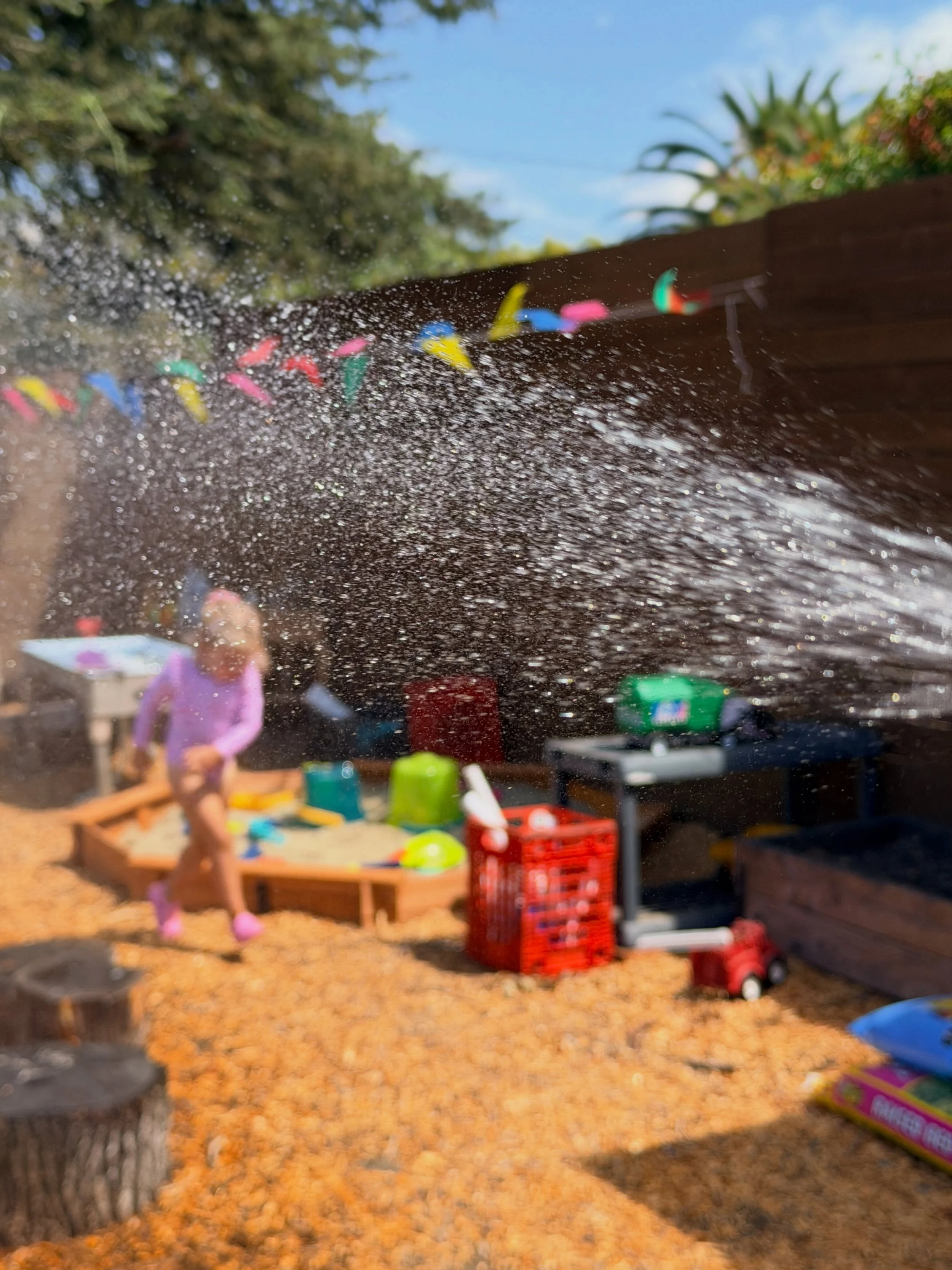 Childhood magic is running through the sprinklers on a hot day 🌈