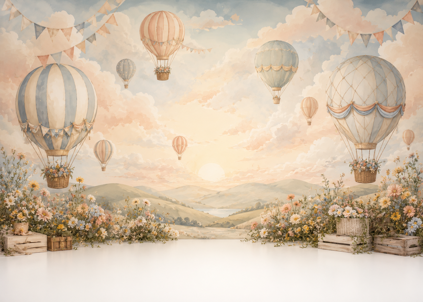 Pastel-colored hot air balloons floating in a sky with clouds during a sunset over rolling hills and a river, with blossoming flowers and crates in the foreground.