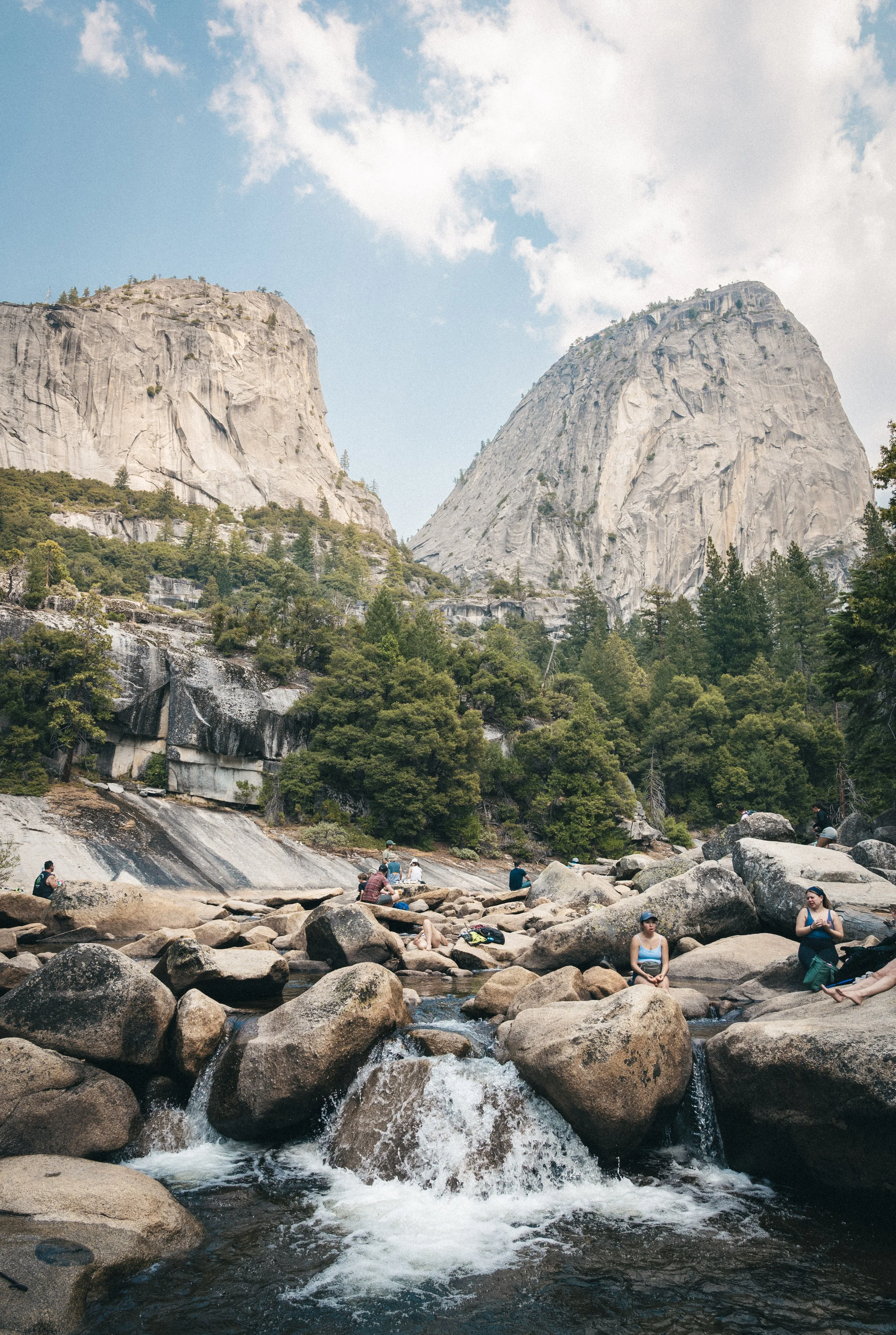 hikers hanging out in the lower falls in Yosemite national park
