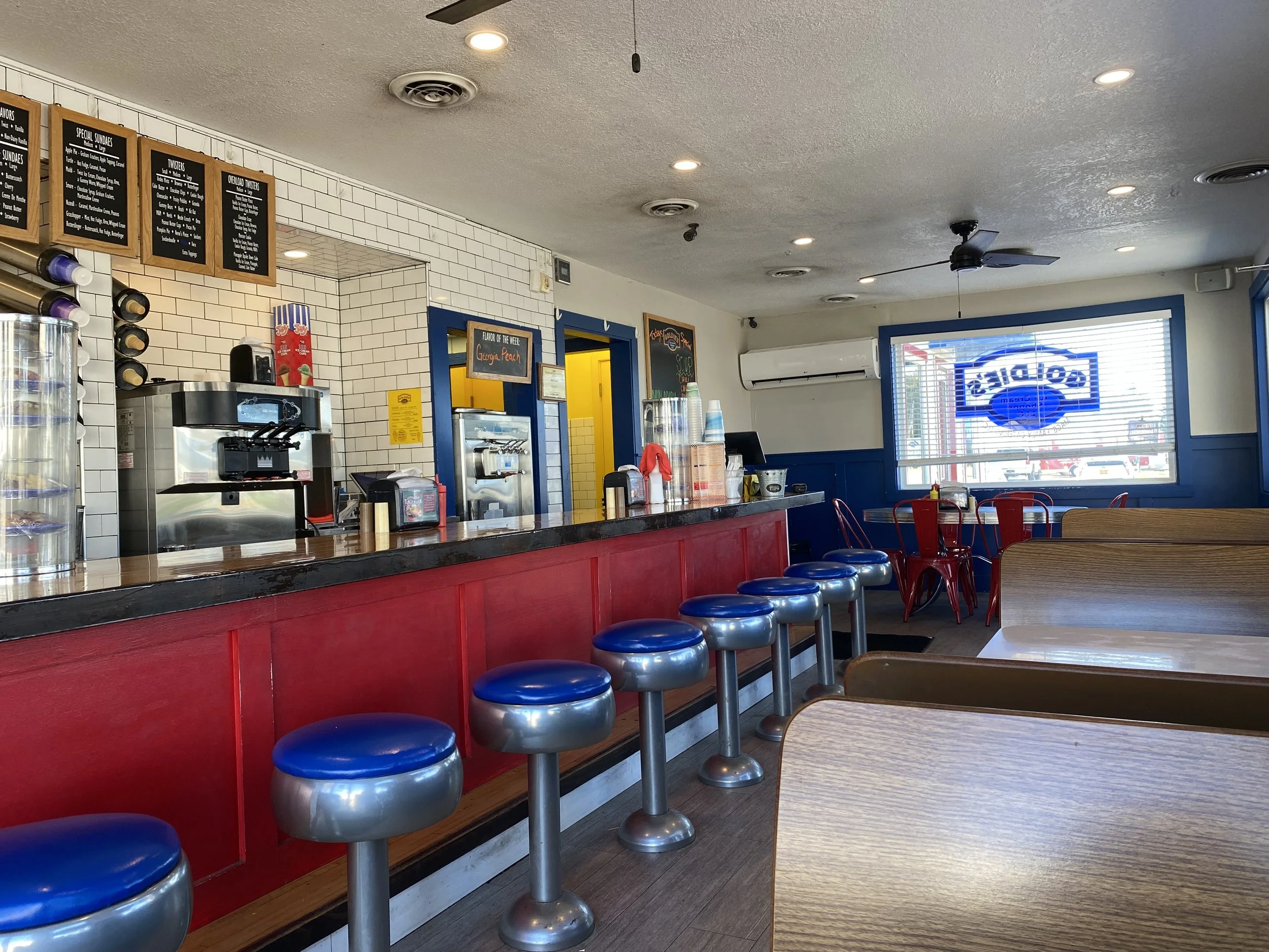 Interior of Goldie's Ice Cream Shoppe, blue barstools along a red counter