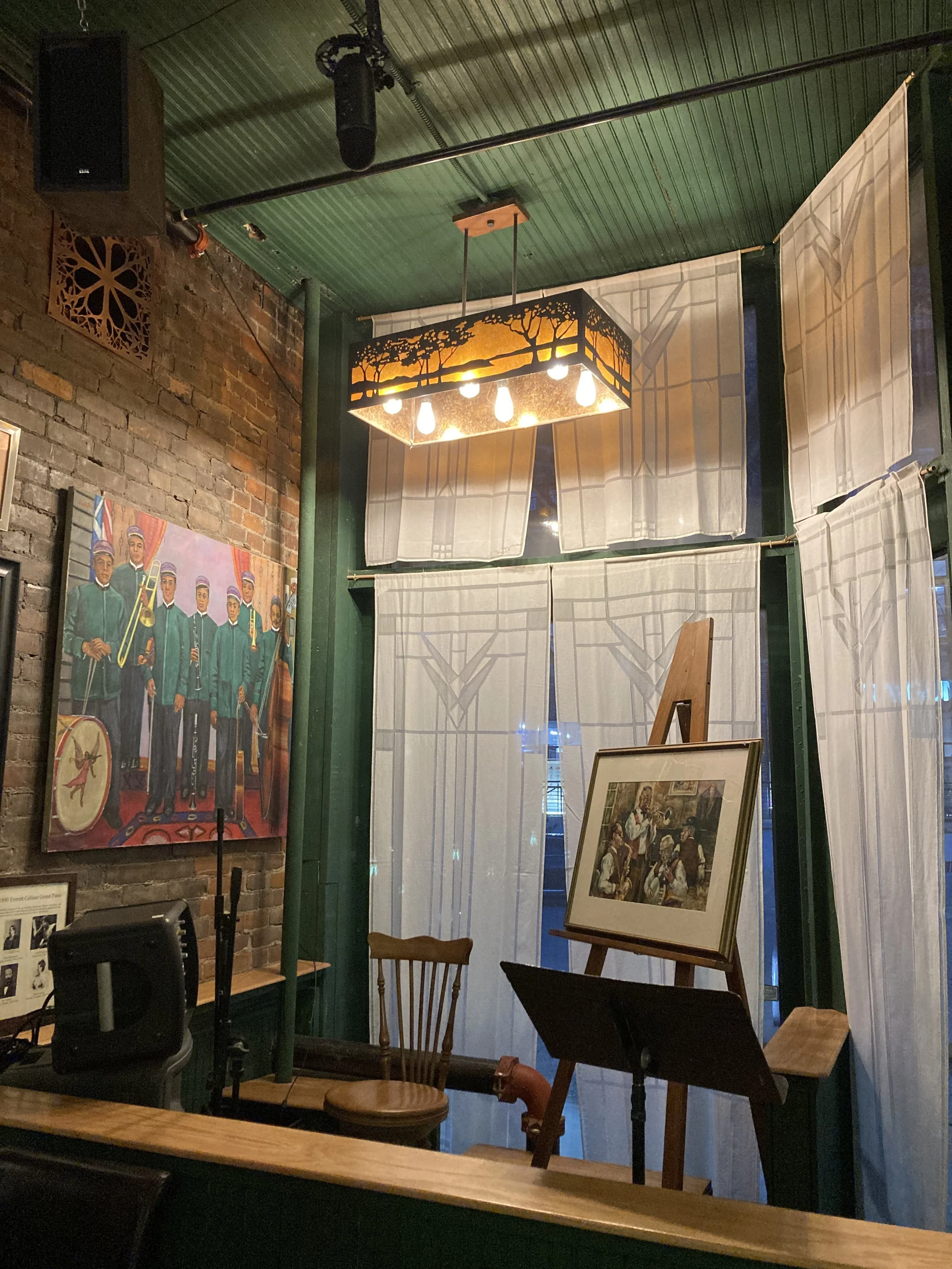 The Bohemian restaurant interior with paintings and white curtains and lamps